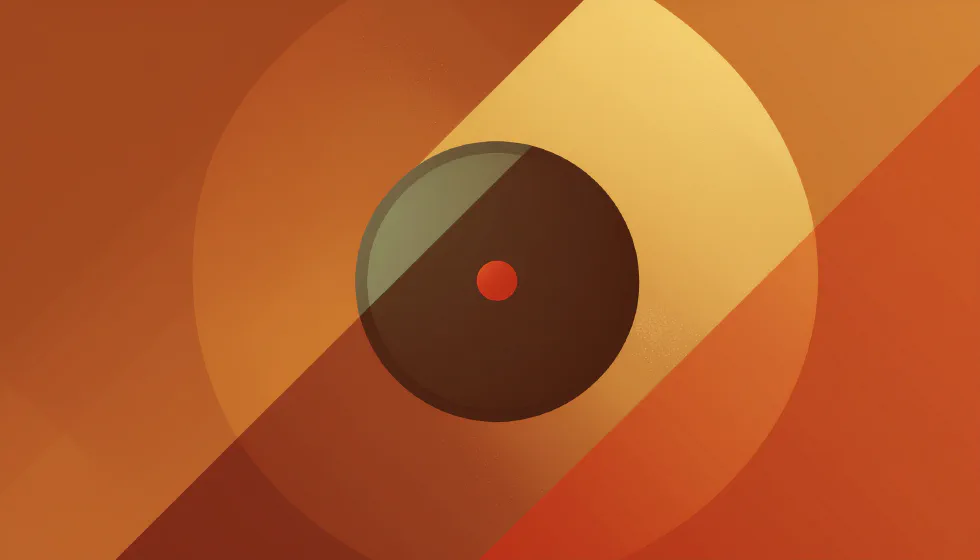 A dark circle with a small red dot at its center, set against warm concentric orange and gold rings
